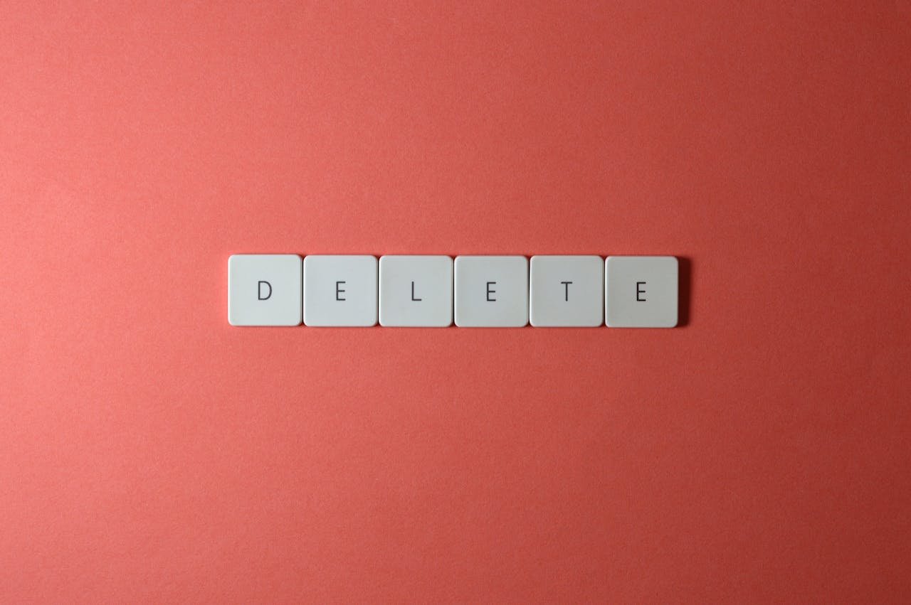 why-choose-us Close-up of keyboard letters spelling 'DELETE' on a coral background, emphasizing digital concepts.